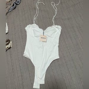 Super down revolve white bodysuit. Never worn.